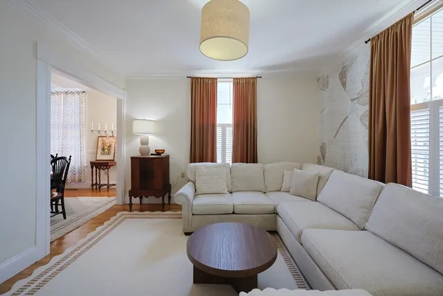 a living room with furniture a window and a chandelier