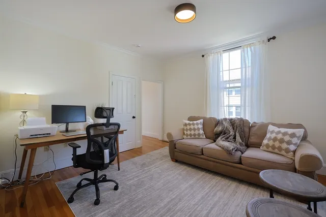a livingroom with workspace and a couch