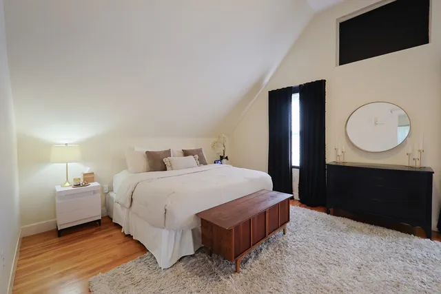 a bedroom with a bed and a dresser