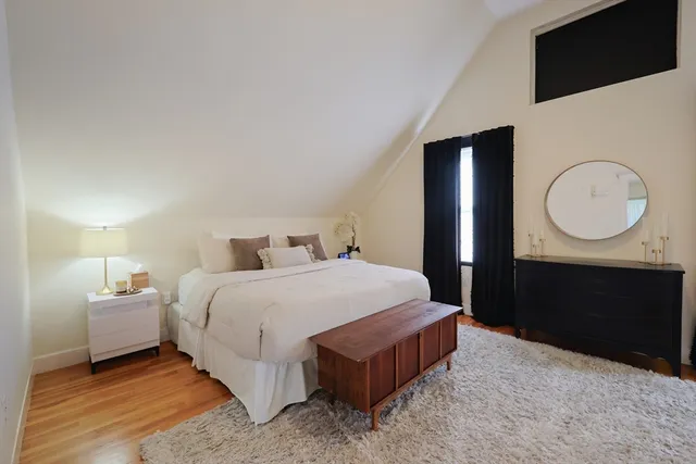 a bedroom with a bed and a dresser