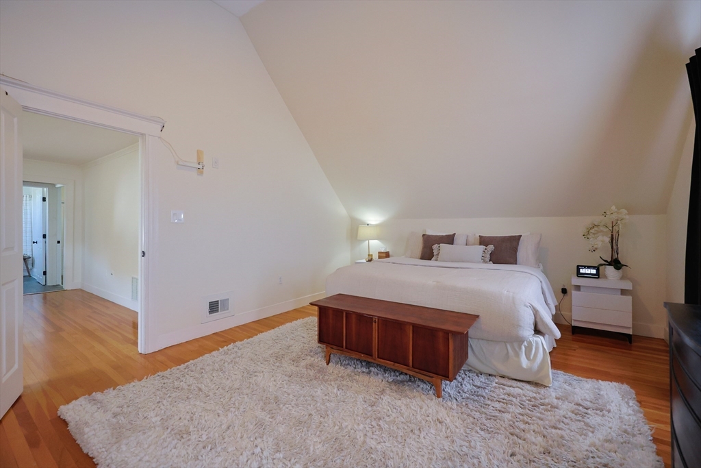 107 Minot Street Boston, MA 02122 - Photo 28 of 42 a bedroom with a bed and wooden floor