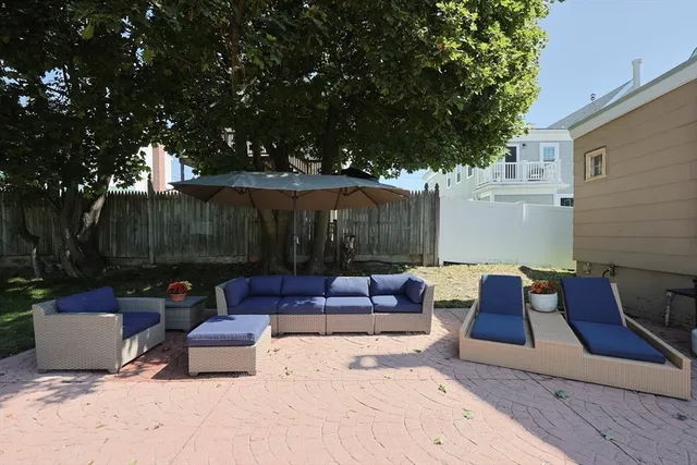 a view of backyard with outdoor seating and green space