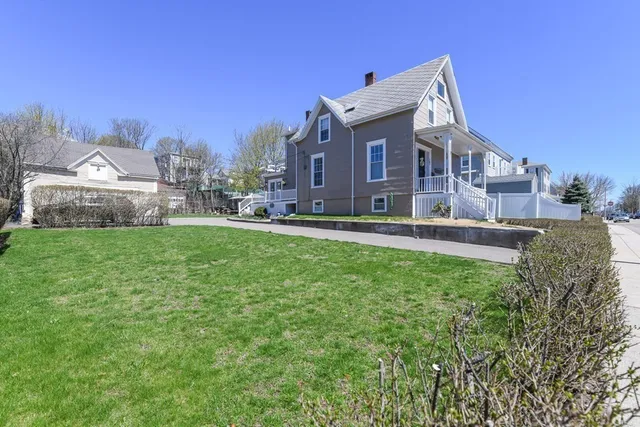 a front view of a house with a yard table and chairs