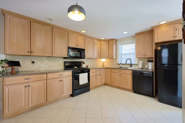 a kitchen with cabinets and appliances