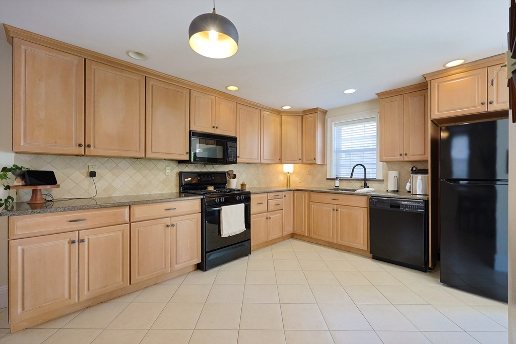 107 Minot Street Boston, MA 02122 - Photo 9 of 42 a kitchen with cabinets and appliances