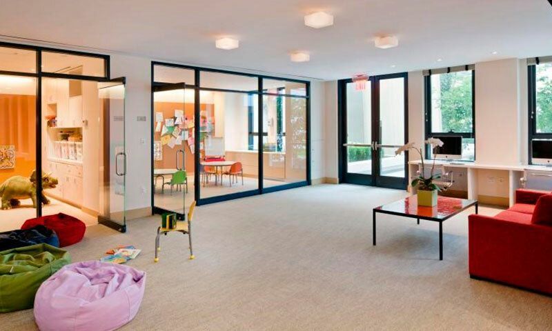 170 East End Avenue, Unit 2G Manhattan, NY 10128 - Photo 14 of 27 a living room with furniture and large windows