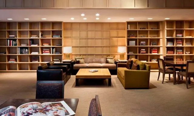 a living room with furniture and a floor to ceiling window