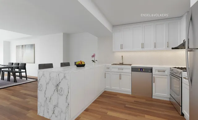 a kitchen with a sink white cabinets and stainless steel appliances