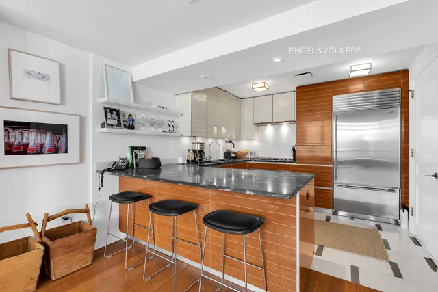 a kitchen with stainless steel appliances granite countertop a stove a sink and a refrigerator