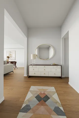 a view of a livingroom with furniture and a mirror