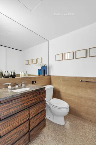 a bathroom with a toilet a sink and a mirror