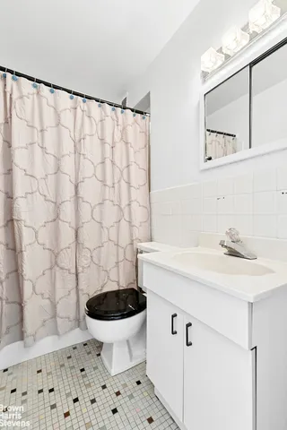 a bathroom with a sink a toilet and a mirror