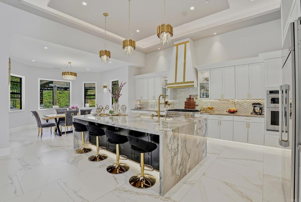 14989 Orchard View Drive Poway, CA 92064 - Photo 18 of 50 a large white kitchen with lots of counter and chairs