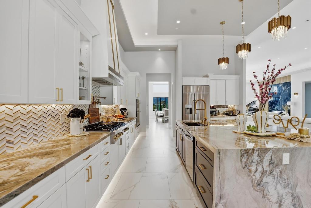 14989 Orchard View Drive Poway, CA 92064 - Photo 20 of 50 a large kitchen with stainless steel appliances kitchen island granite countertop a sink and cabinets