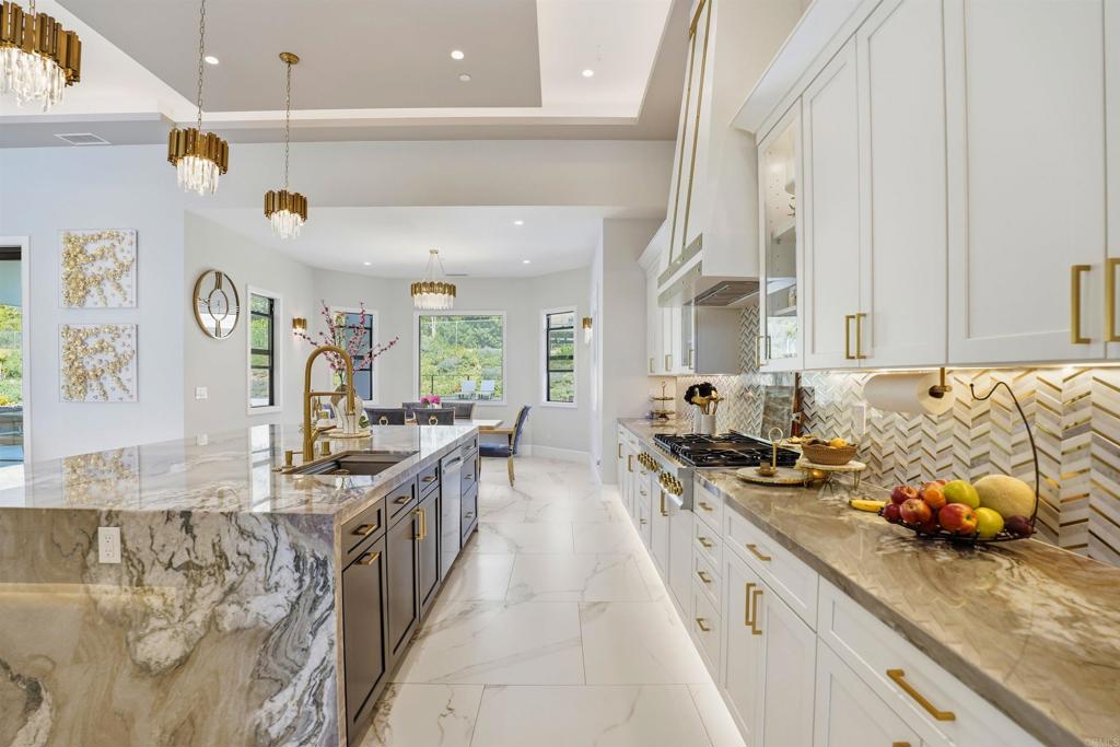 14989 Orchard View Drive Poway, CA 92064 - Photo 21 of 50 a kitchen with sink stove and cabinets