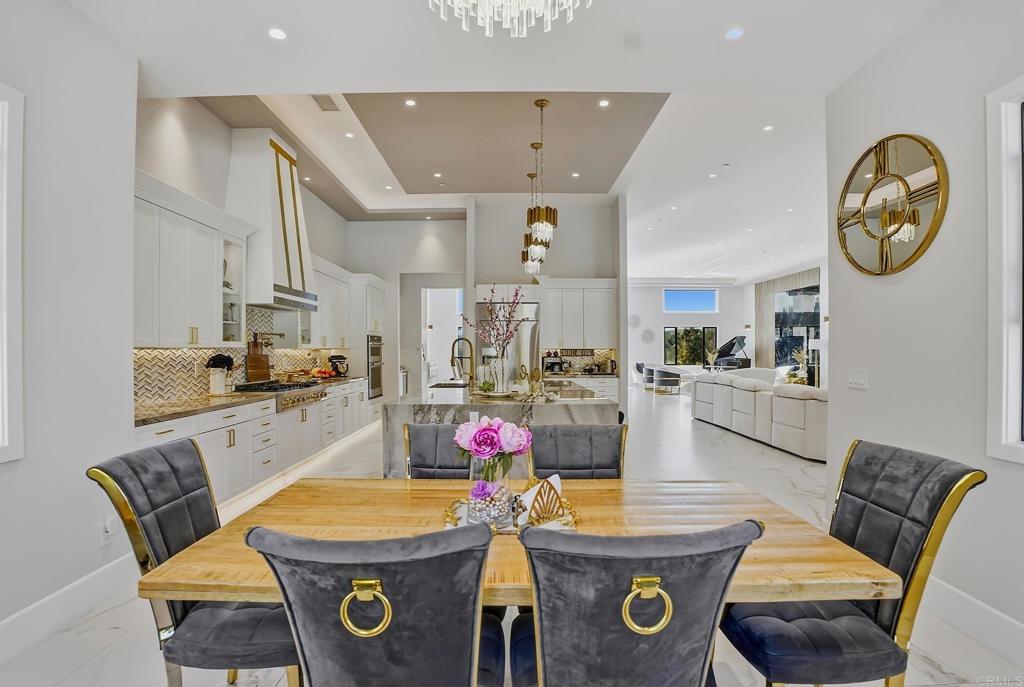 14989 Orchard View Drive Poway, CA 92064 - Photo 23 of 50 a very nice looking open dining room with kitchen island furniture and a chandelier