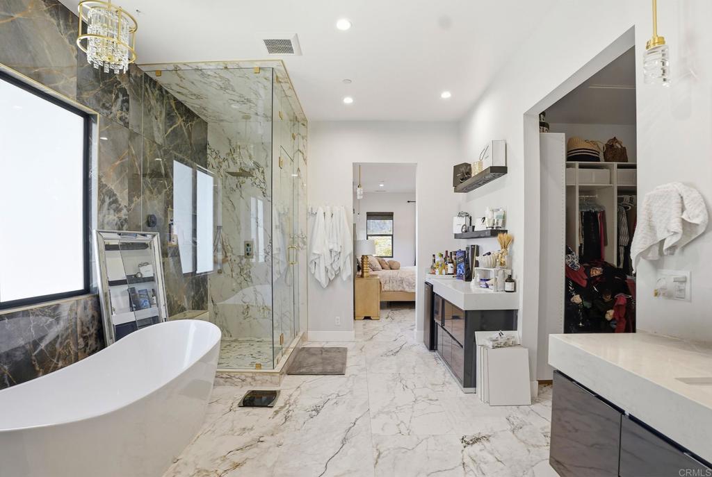 14989 Orchard View Drive Poway, CA 92064 - Photo 28 of 50 a spacious bathroom with a double vanity sink toilet and shower