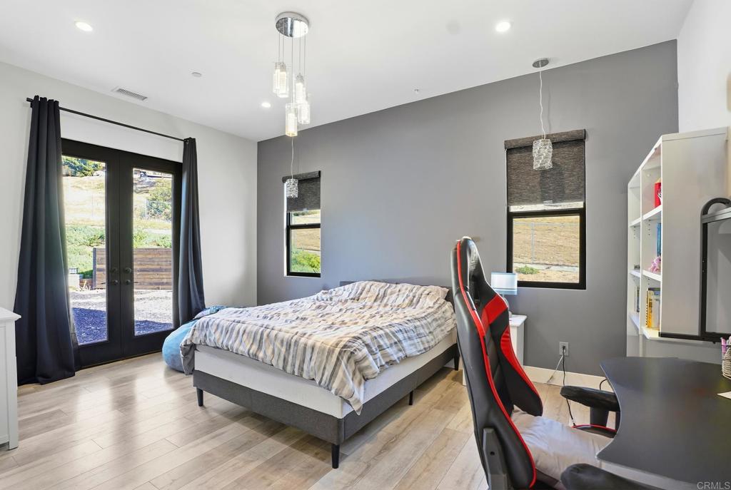 14989 Orchard View Drive Poway, CA 92064 - Photo 32 of 50 a bedroom with a bed wooden floor and window