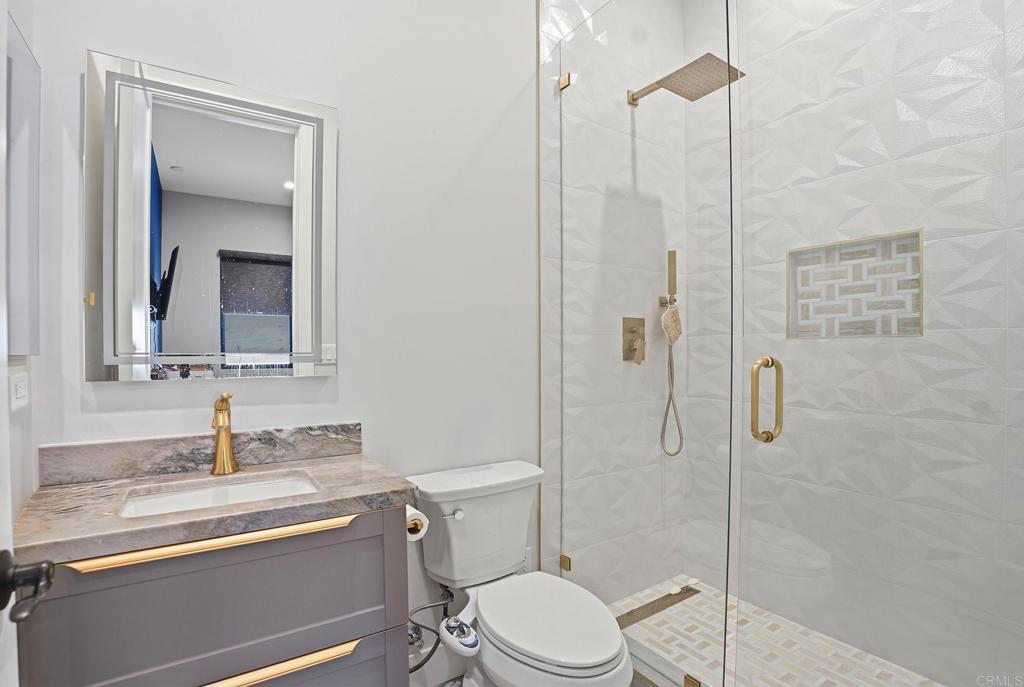 14989 Orchard View Drive Poway, CA 92064 - Photo 35 of 50 a bathroom with a toilet a sink and shower