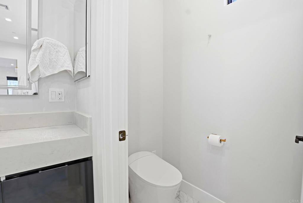 14989 Orchard View Drive Poway, CA 92064 - Photo 37 of 50 a bathroom with a sink a toilet and a mirror