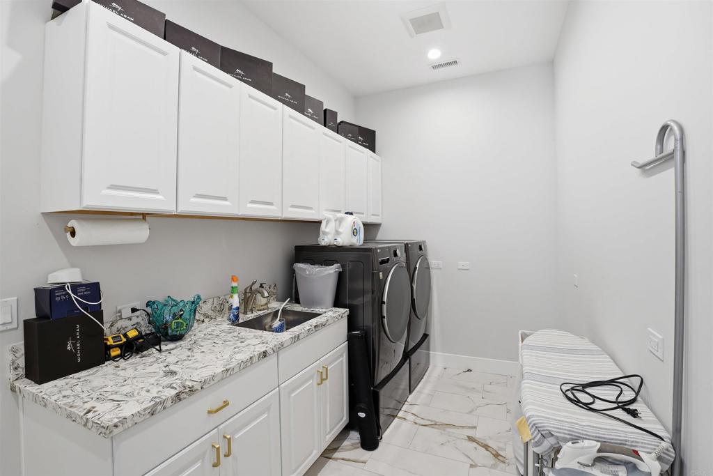14989 Orchard View Drive Poway, CA 92064 - Photo 40 of 50 a kitchen with a sink a stove and cabinets