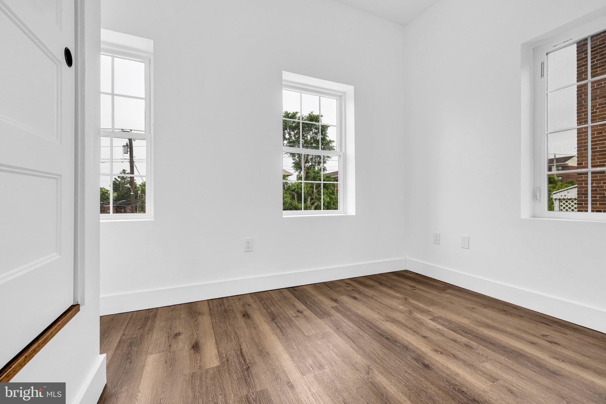 2801 Round Road Baltimore, MD 21225 - Photo 17 of 29 an empty room with wooden floor and windows