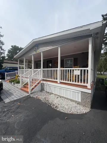 a view of a house with a wooden deck