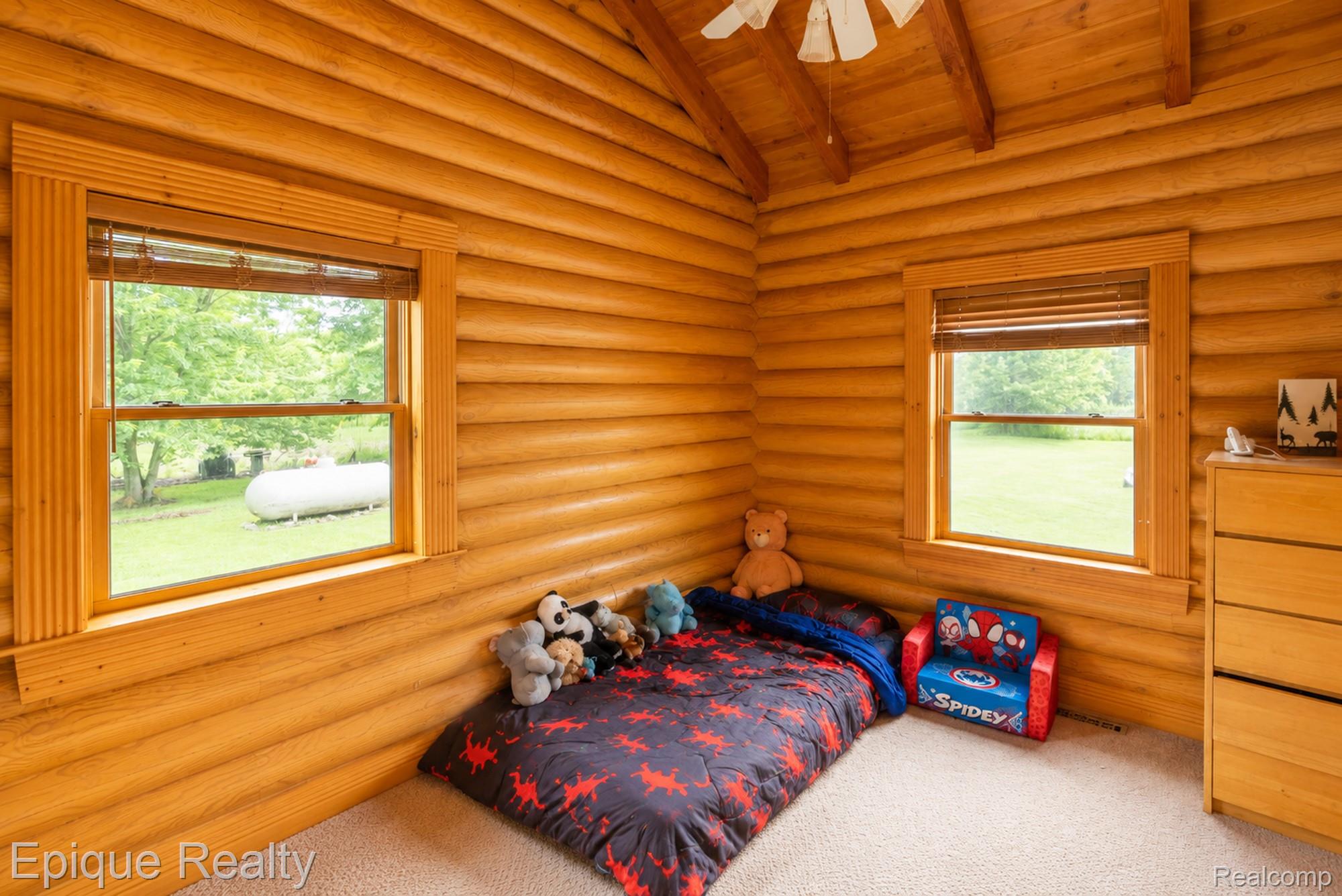 1966 Mayer Road Smiths Creek, MI 48074 - Photo 22 of 38 Wood-paneled room featuring exposed wood beams and a ceiling fan