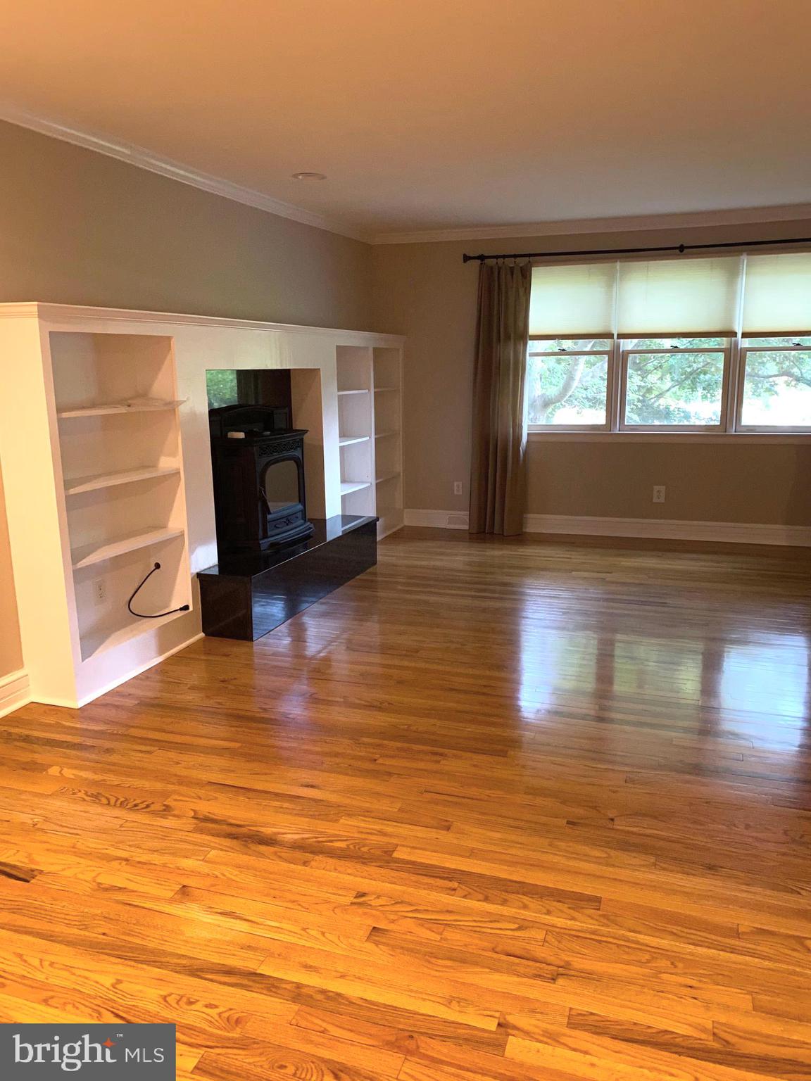 Living Rm with Pellet Stove and gleaming hardwood