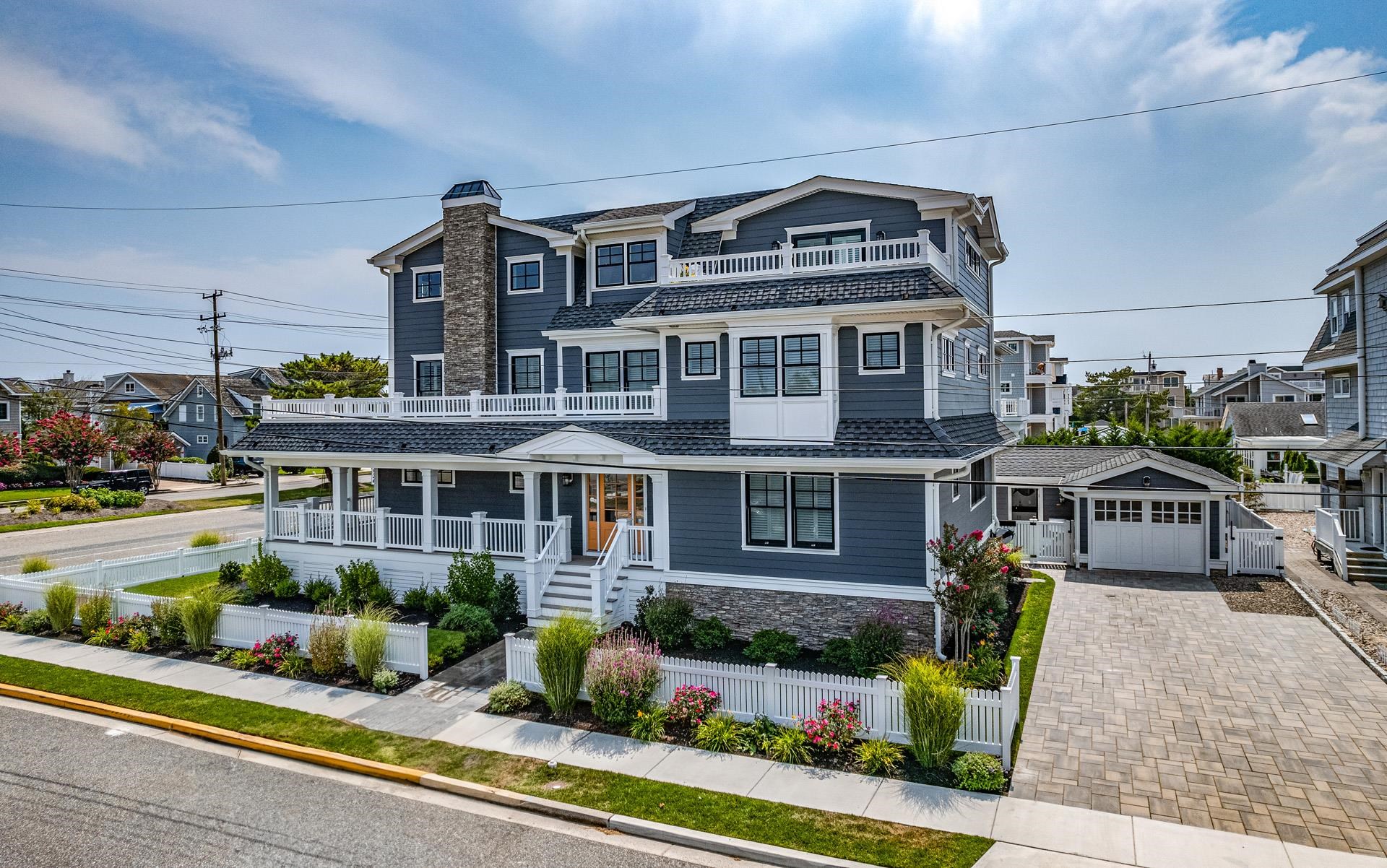 7418 Dune Drive Avalon, NJ 08202 - Photo 1 of 50 a front view of a residential apartment building with a yard and potted plants
