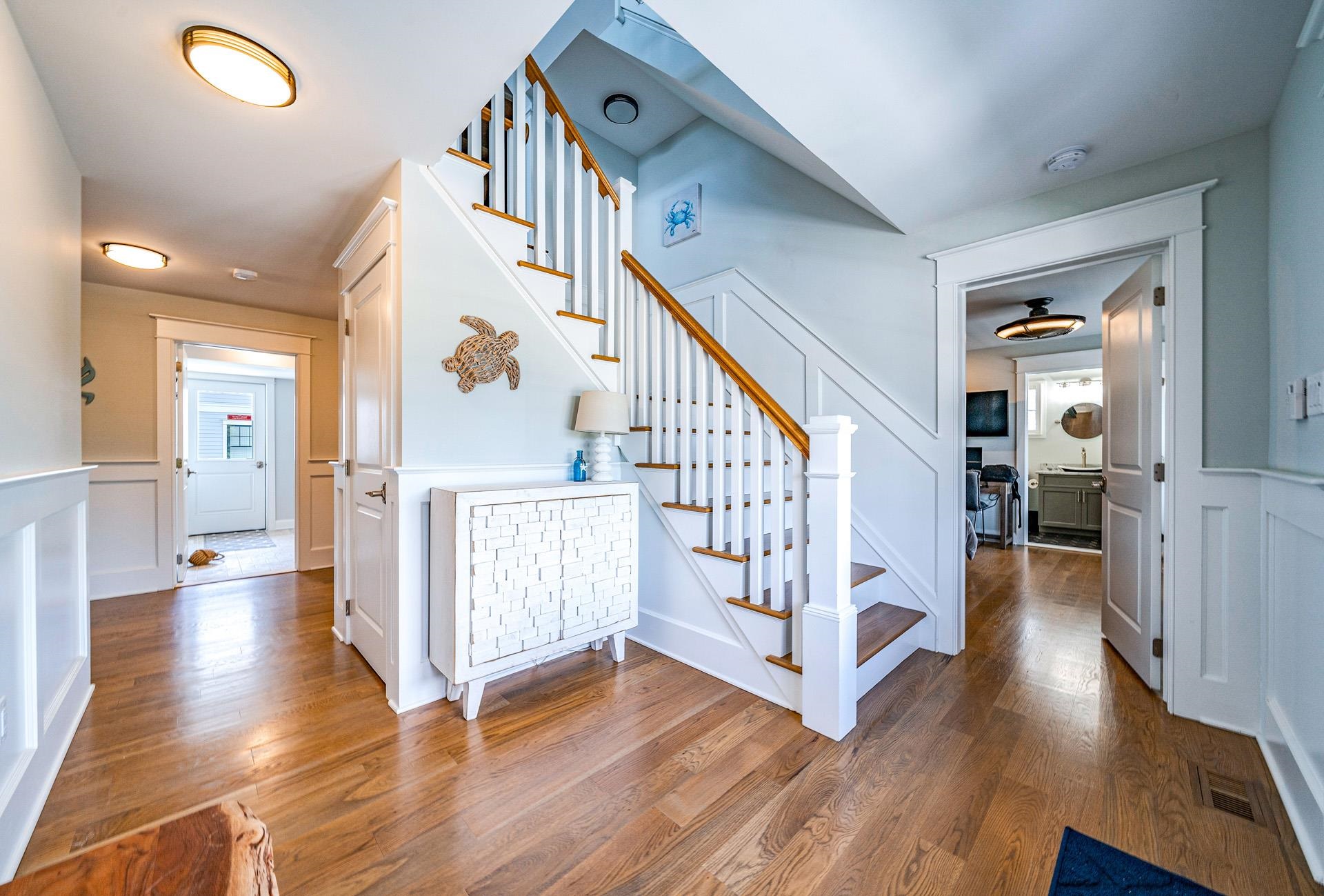 7418 Dune Drive Avalon, NJ 08202 - Photo 13 of 50 a view of entryway with wooden floor and stairs