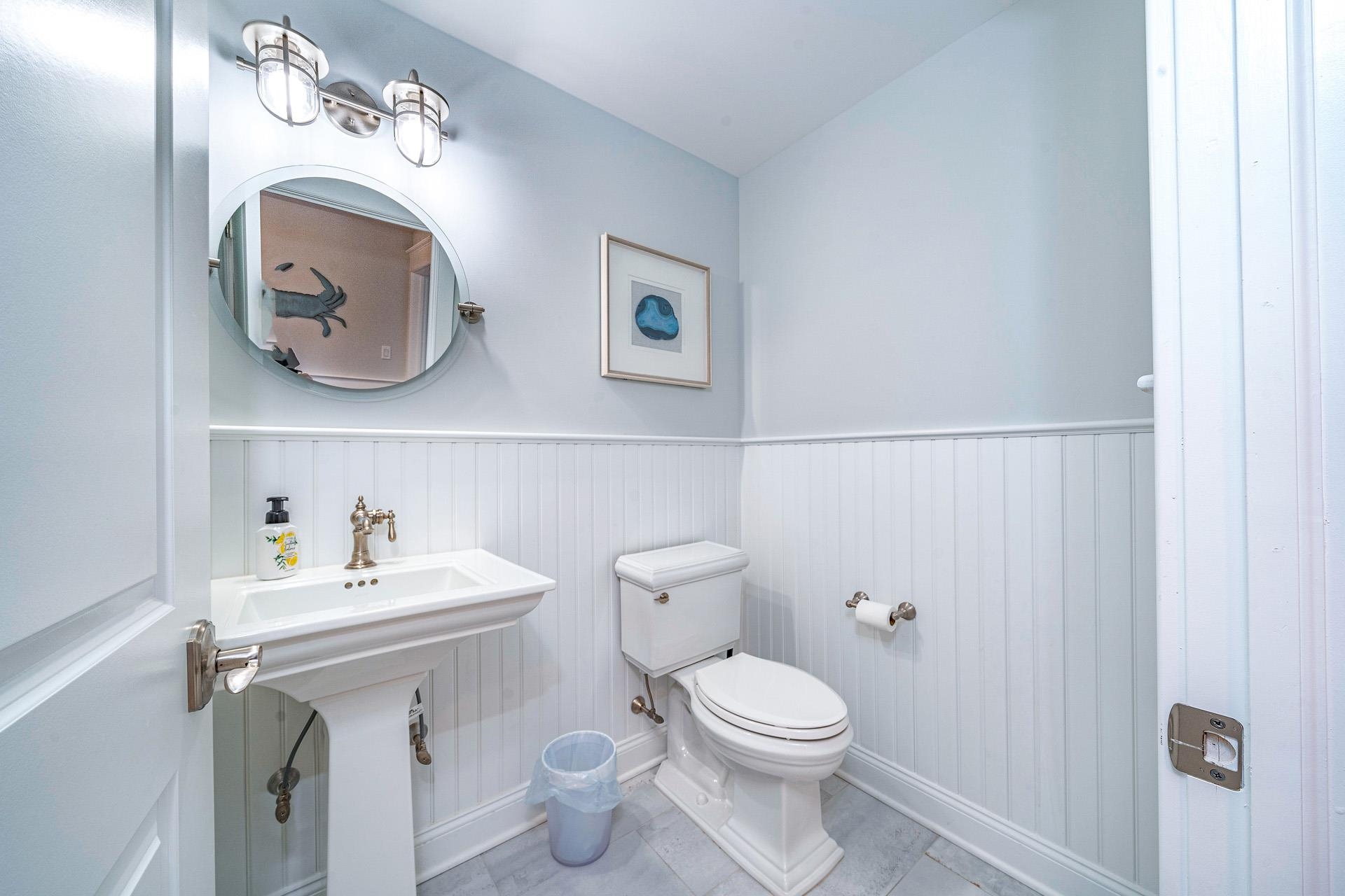 7418 Dune Drive Avalon, NJ 08202 - Photo 16 of 50 a bathroom with a toilet a sink and mirror
