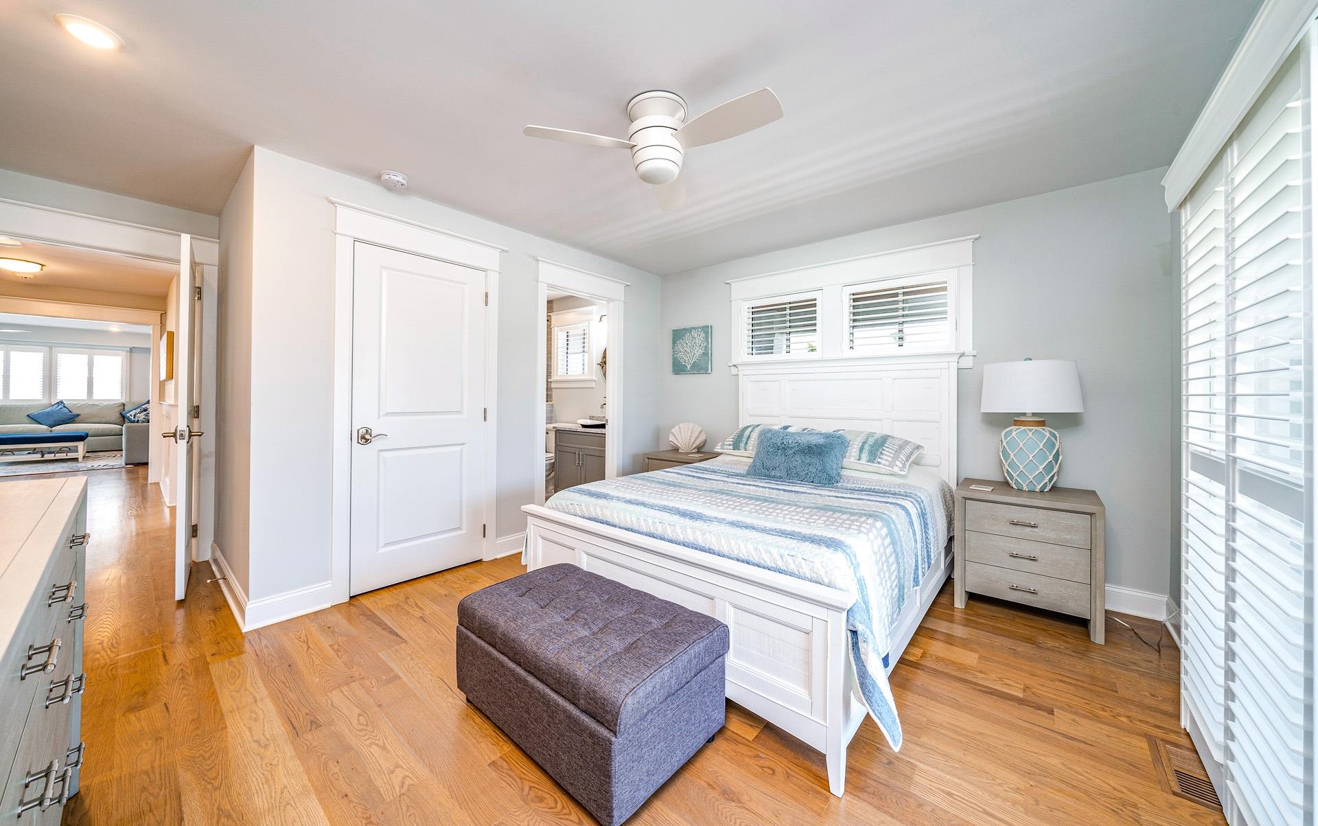 7418 Dune Drive Avalon, NJ 08202 - Photo 20 of 50 a spacious bedroom with a bed and a chandelier