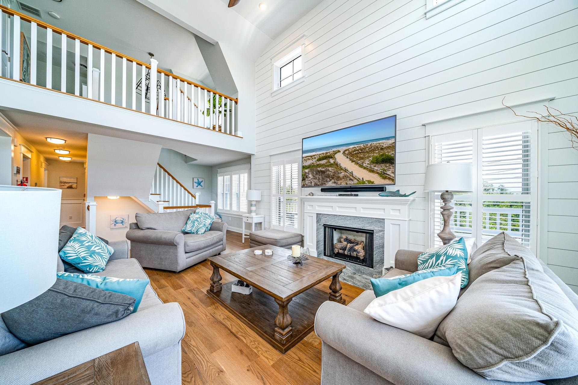 7418 Dune Drive Avalon, NJ 08202 - Photo 28 of 50 a living room with furniture a fireplace and a flat screen tv