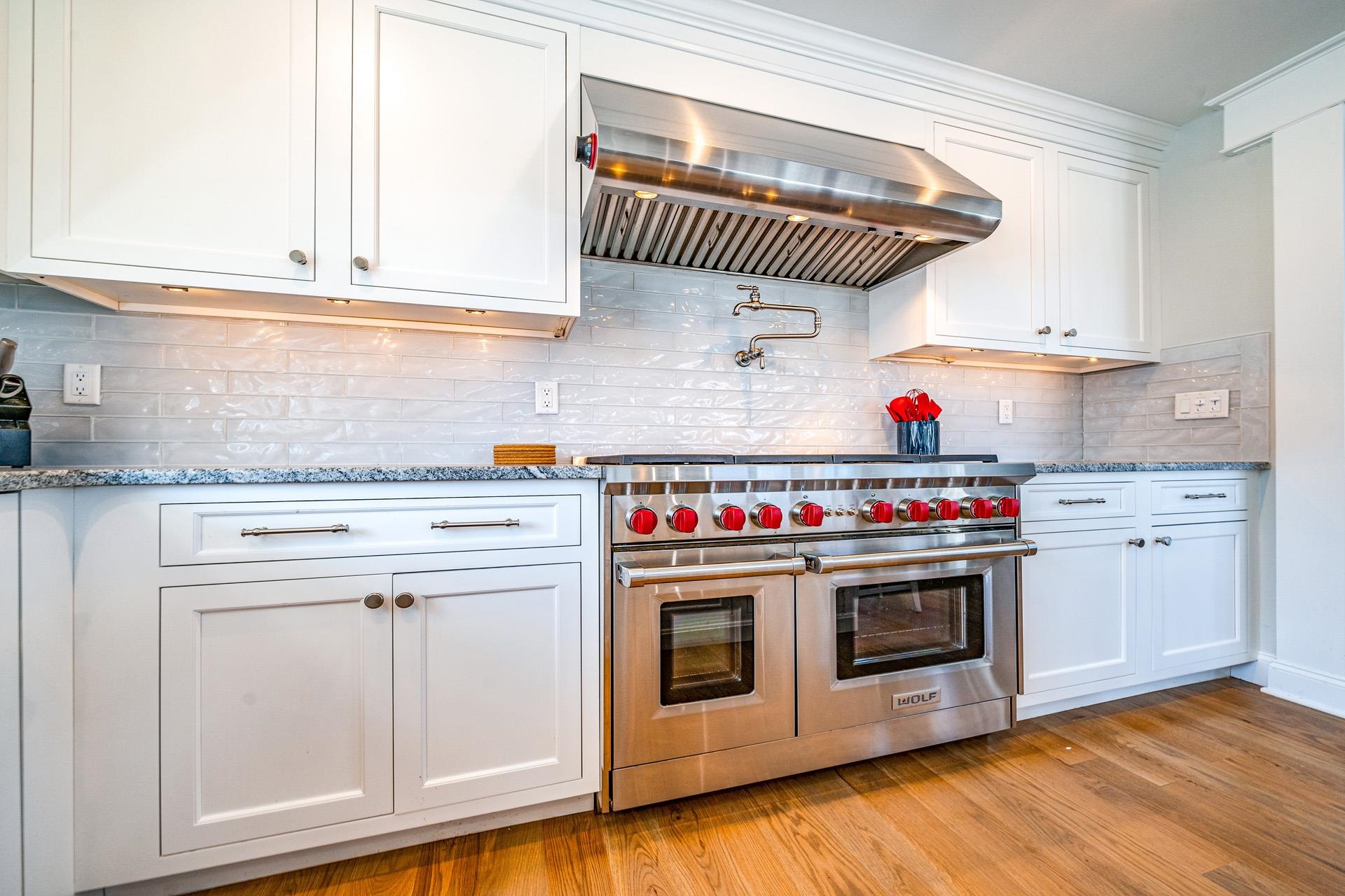 7418 Dune Drive Avalon, NJ 08202 - Photo 33 of 50 a kitchen with granite countertop a stove and a wooden floors