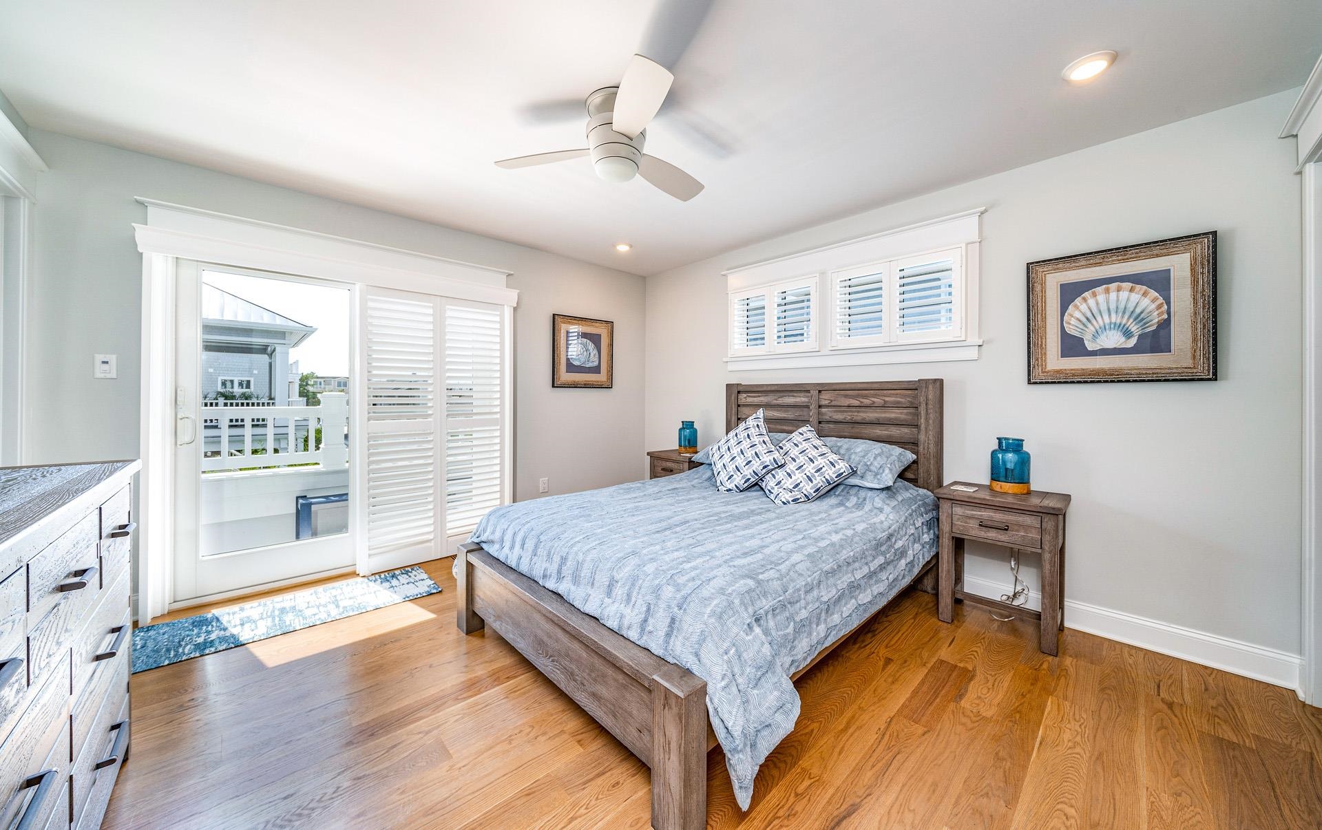 7418 Dune Drive Avalon, NJ 08202 - Photo 37 of 50 a spacious bedroom with a large bed and a chandelier