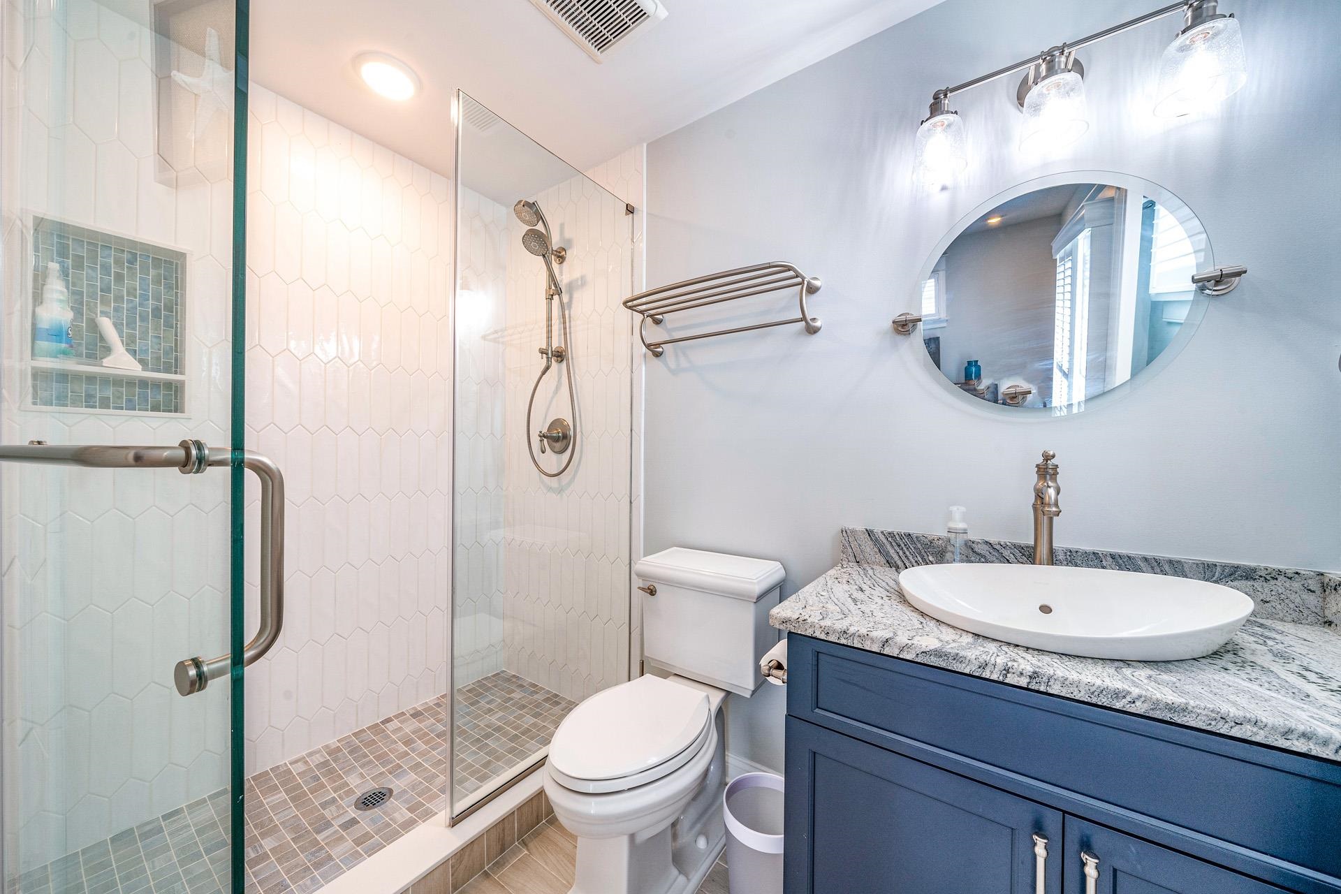7418 Dune Drive Avalon, NJ 08202 - Photo 38 of 50 a bathroom with a toilet a sink and mirror