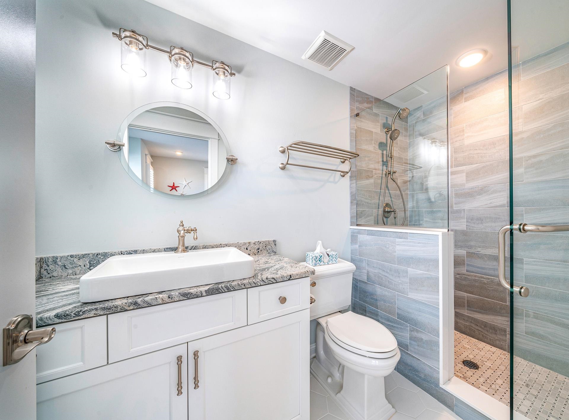 7418 Dune Drive Avalon, NJ 08202 - Photo 40 of 50 a bathroom with a granite countertop toilet sink and mirror
