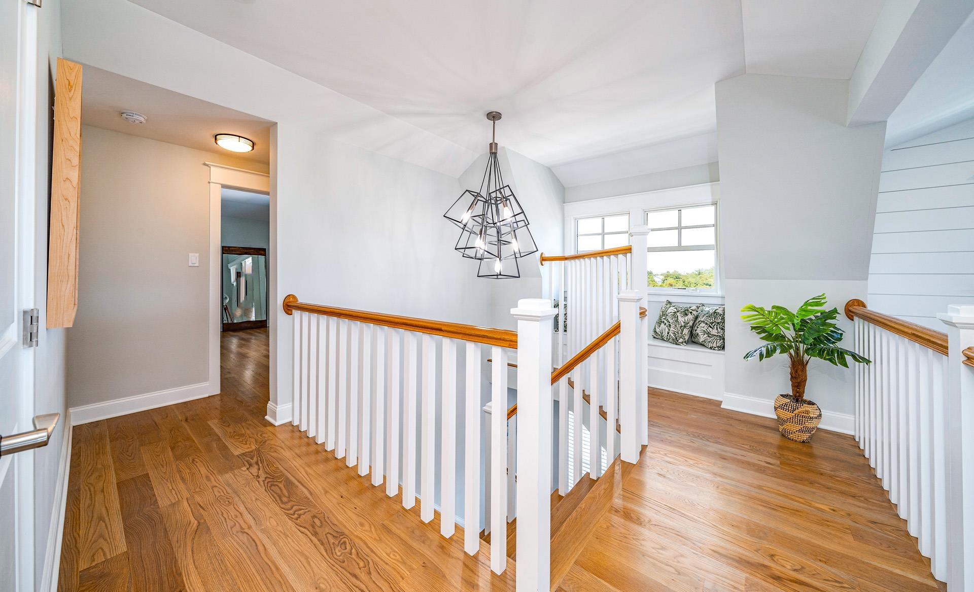 7418 Dune Drive Avalon, NJ 08202 - Photo 42 of 50 a view of a hallway to a livingroom with wooden floor and stairs