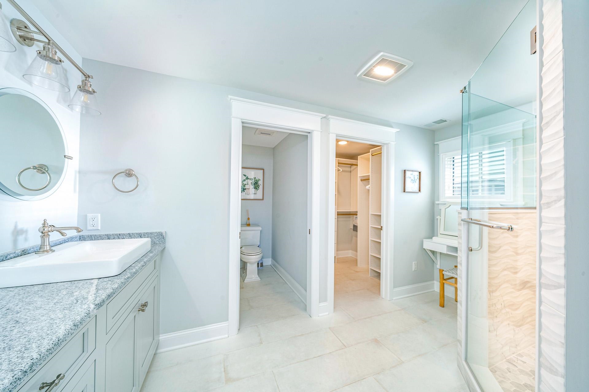 7418 Dune Drive Avalon, NJ 08202 - Photo 46 of 50 a spacious bathroom with a granite countertop sink and a mirror