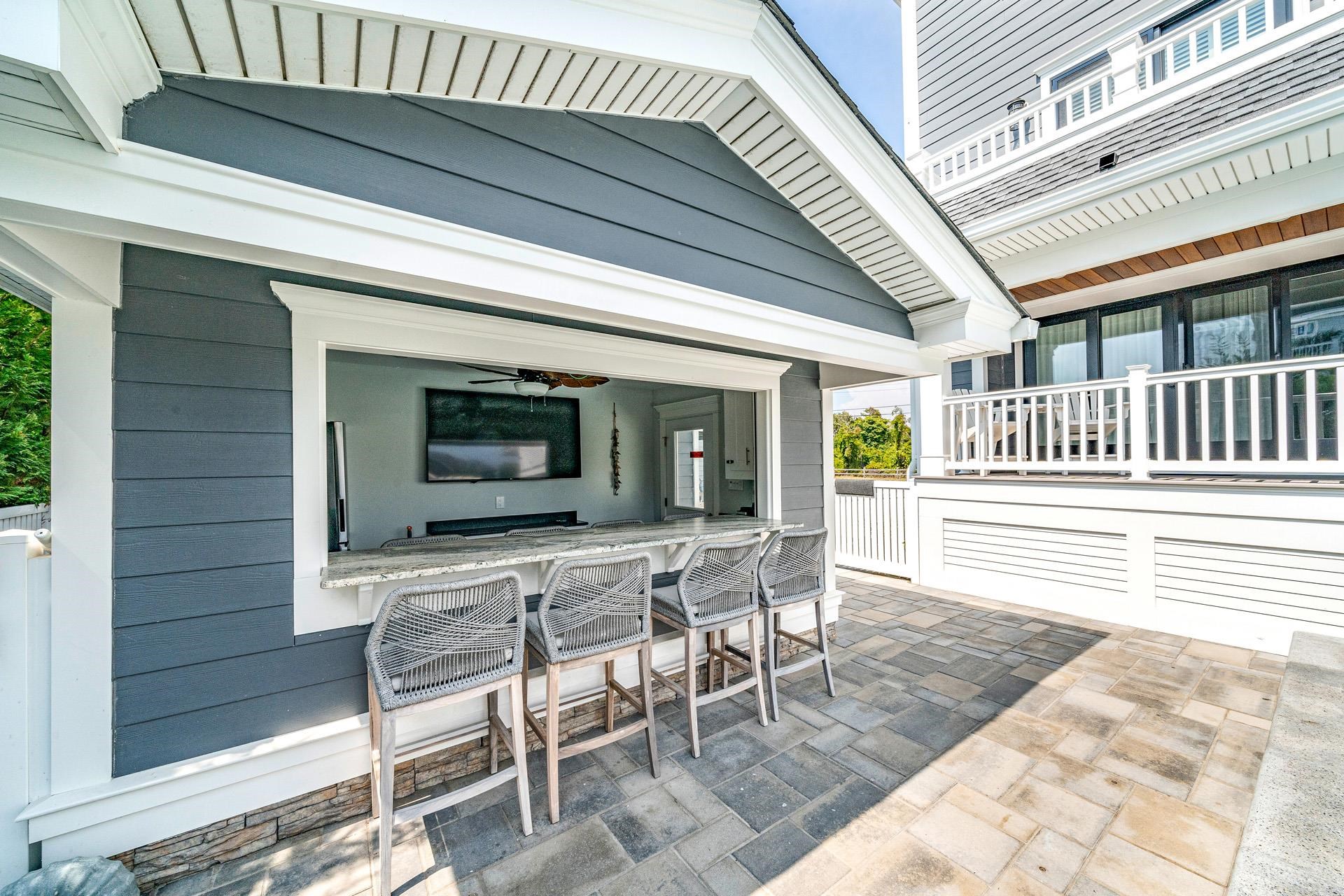 7418 Dune Drive Avalon, NJ 08202 - Photo 8 of 50 a view of a house with a chairs and table in a patio