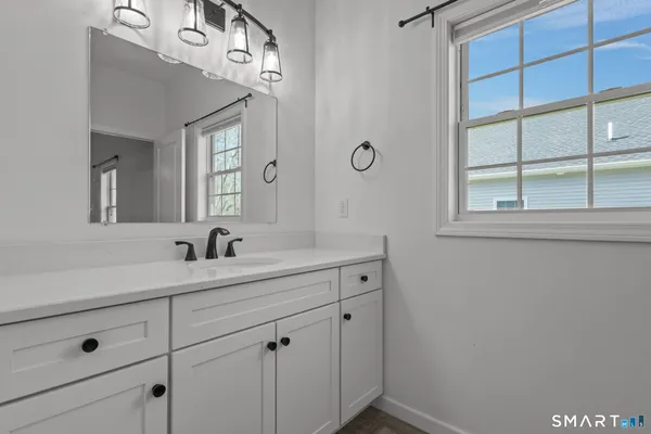 a bathroom with a sink a vanity and a mirror