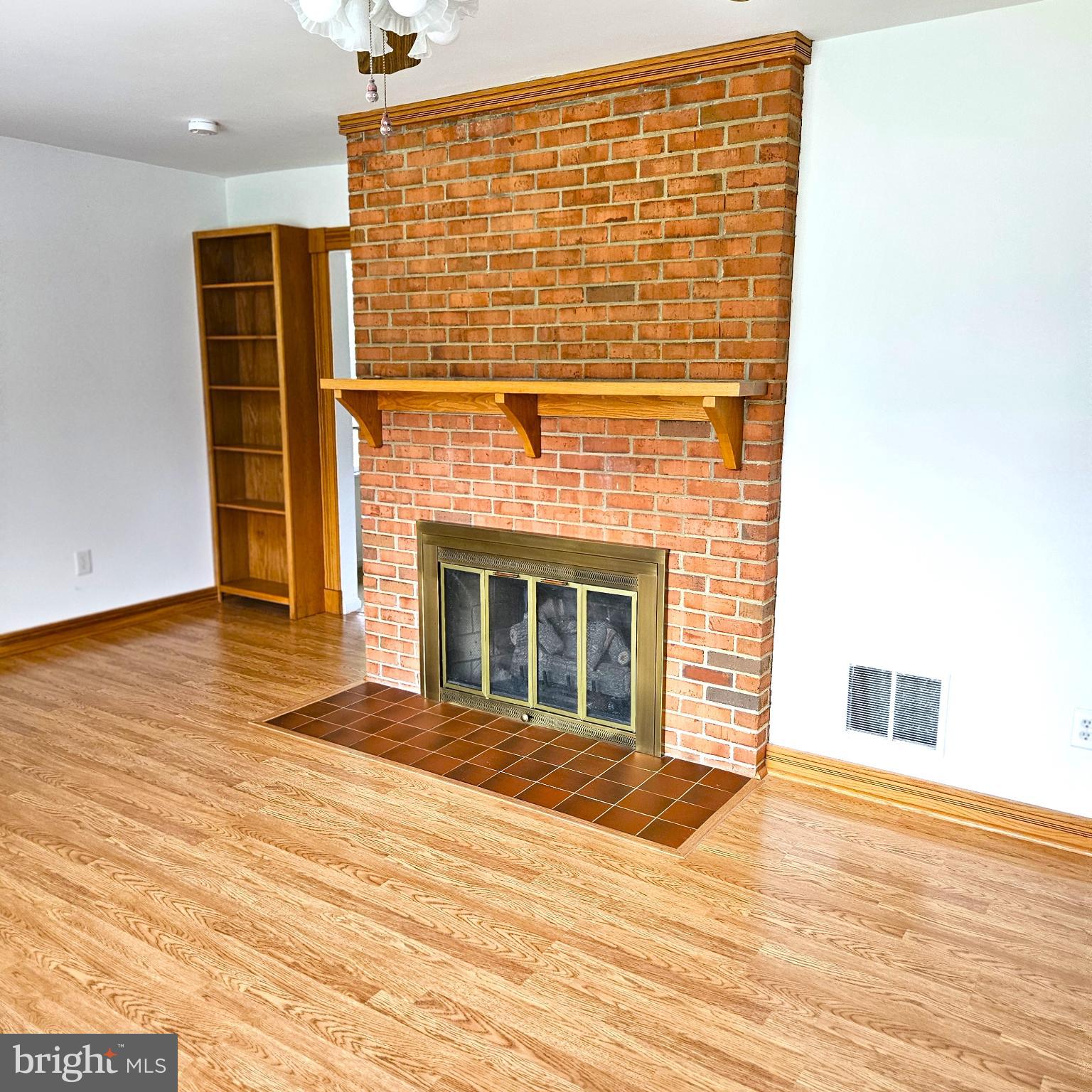 7 Skyline Lane Washington, VA 22747 - Photo 19 of 42 a view of an empty room with wooden floor and a fireplace