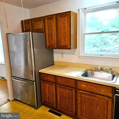 a kitchen with a refrigerator and a sink