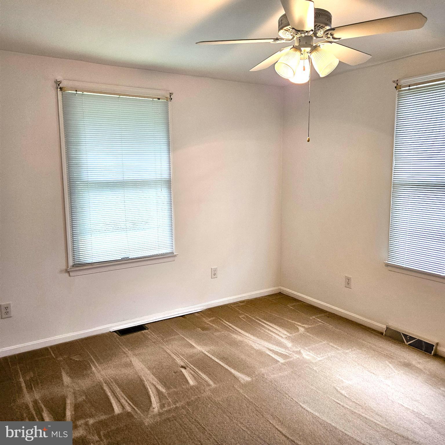 7 Skyline Lane Washington, VA 22747 - Photo 31 of 42 an empty room with a window and chandelier fan