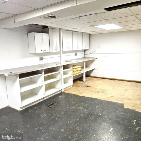 a view of a livingroom with wooden floor and a ceiling fan
