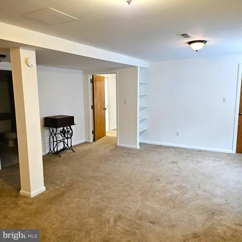 a room with a dresser and mirror