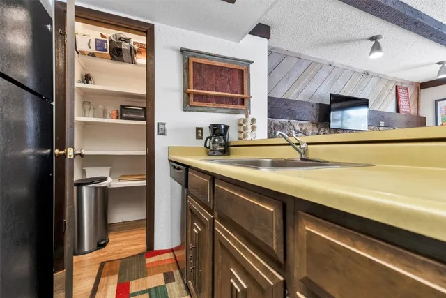 a bathroom with a granite countertop sink a toilet and shower