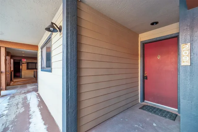a living room with furniture a flat screen tv and a floor to ceiling window