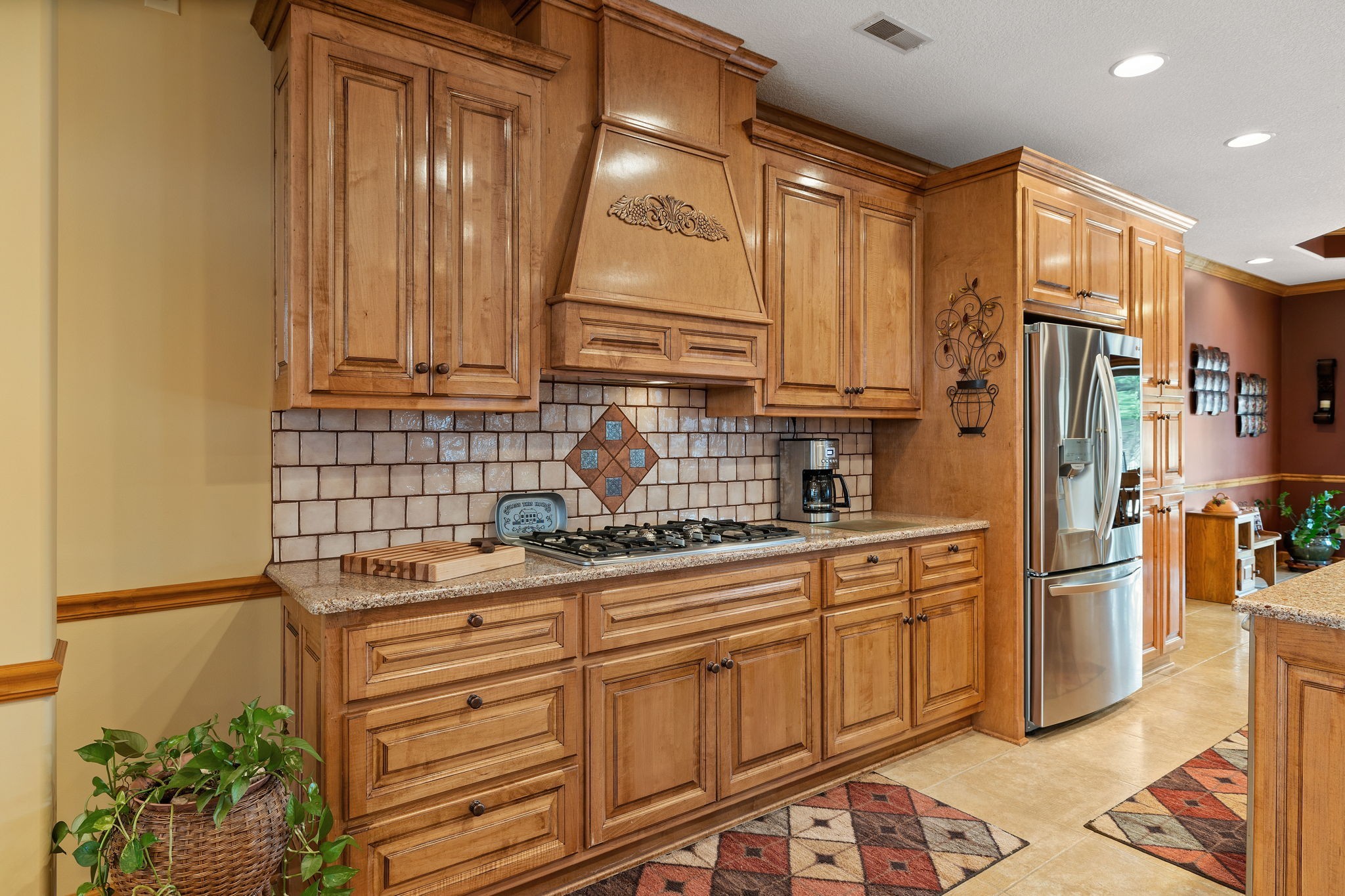 469 Pickney Road Winchester, TN 37398 - Photo 11 of 49 Kitchen has gas cooktop, tiled backsplash, and stainless-steel appliances and tile floors.